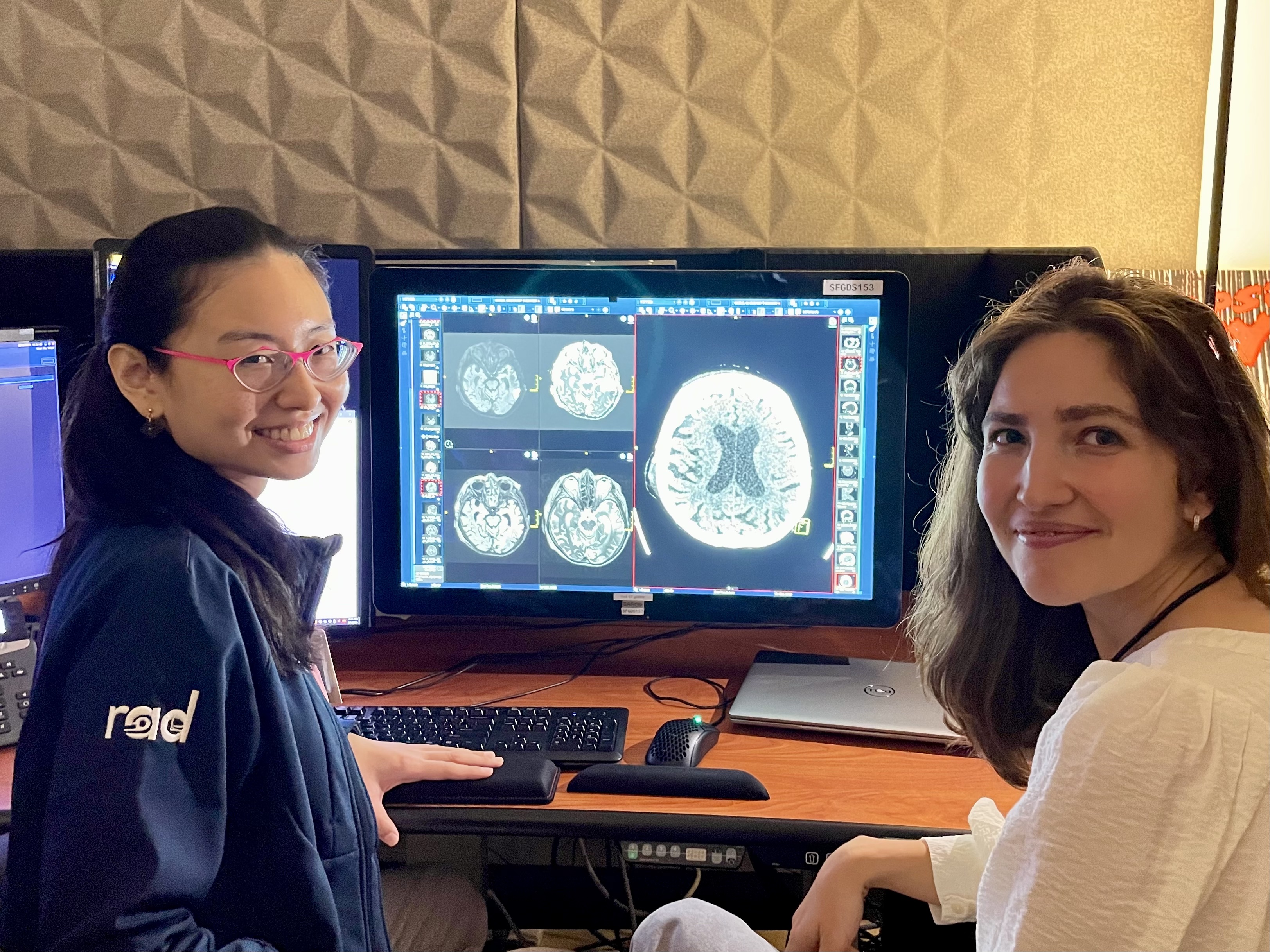 Weiya Mu, MD, and Resident Simona Morochnik, MD, PhD. Two women smiling at a computer workstation.