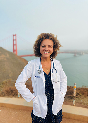 Headshot of Allison, a RIDR intern, wearing a white doctor's coach with the Golden Gate Bridge in the background