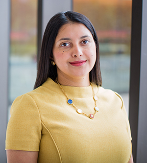 Priyanka Jha, MBBS, UCSF Radiology faculty author of O-RADS research smiling while wearing a yellow shirt and necklace