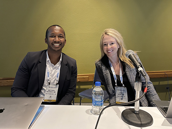 Matthew Bucknor, MD (left) with Erin Alaia, MD, (right) from NYU Langone Radiology, taken before leading a session on imaging of musculoskeletal infections A man and a woman seated at a table presenting for a conference