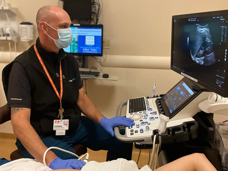 George Glover performing an ultrasound