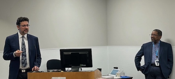 Chair Chris Hess and Dean Talmadge King Two men standing on either side of a podium