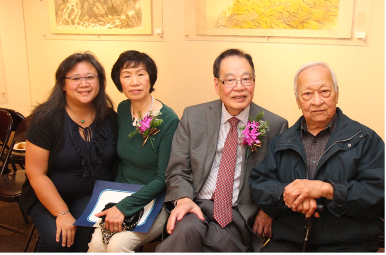 Cindy Cheng with her art teacher Kan Kwok Fan and his wife (center), and Cindy’s father PK Cheng (right). People posing for a group picture.
