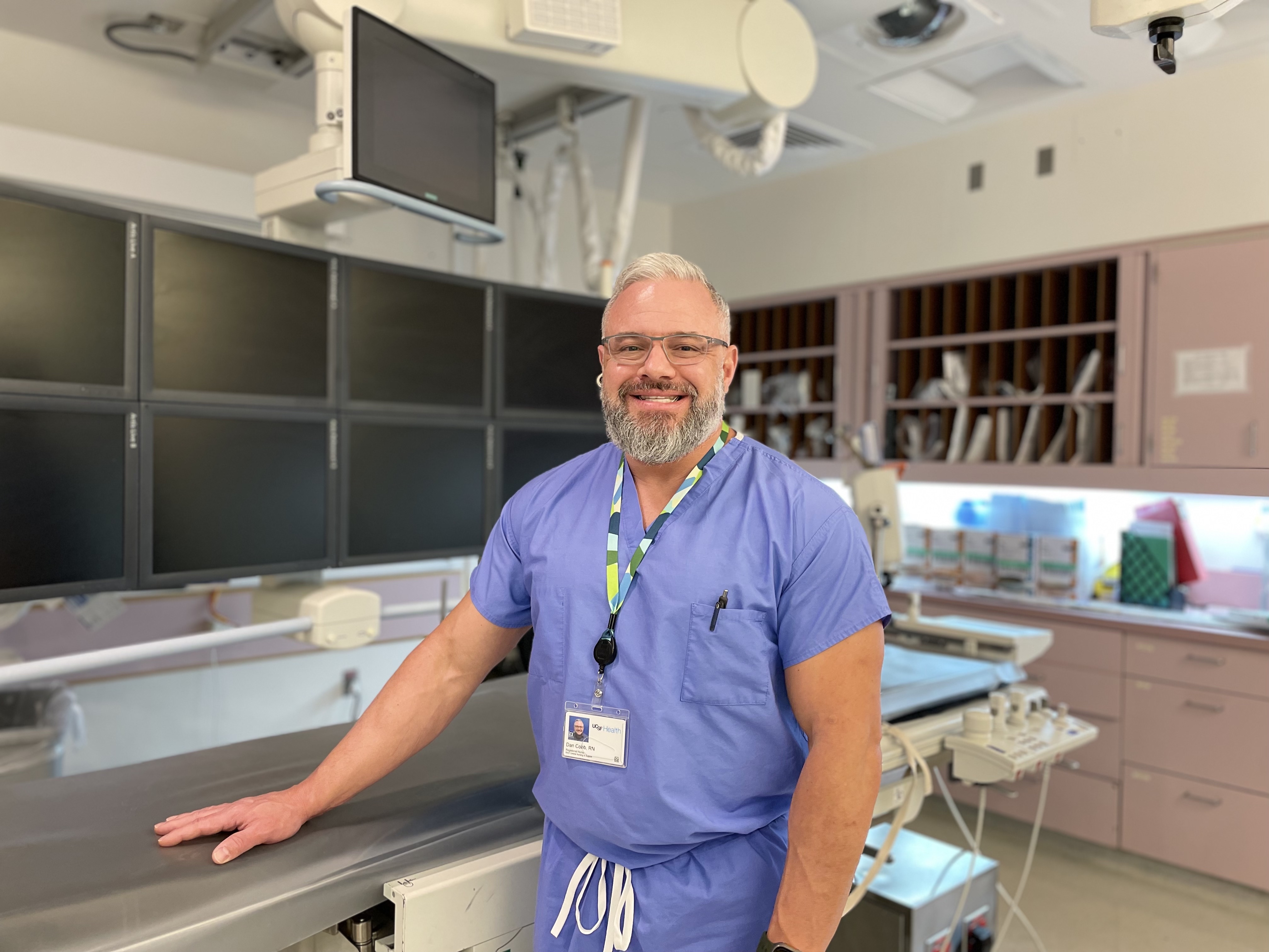Nurse Daniel Cobb, at UCSF Helen Diller Medical Center at Parnassus Heights. A man standing in a patient exam room at UCSF Medical Center.