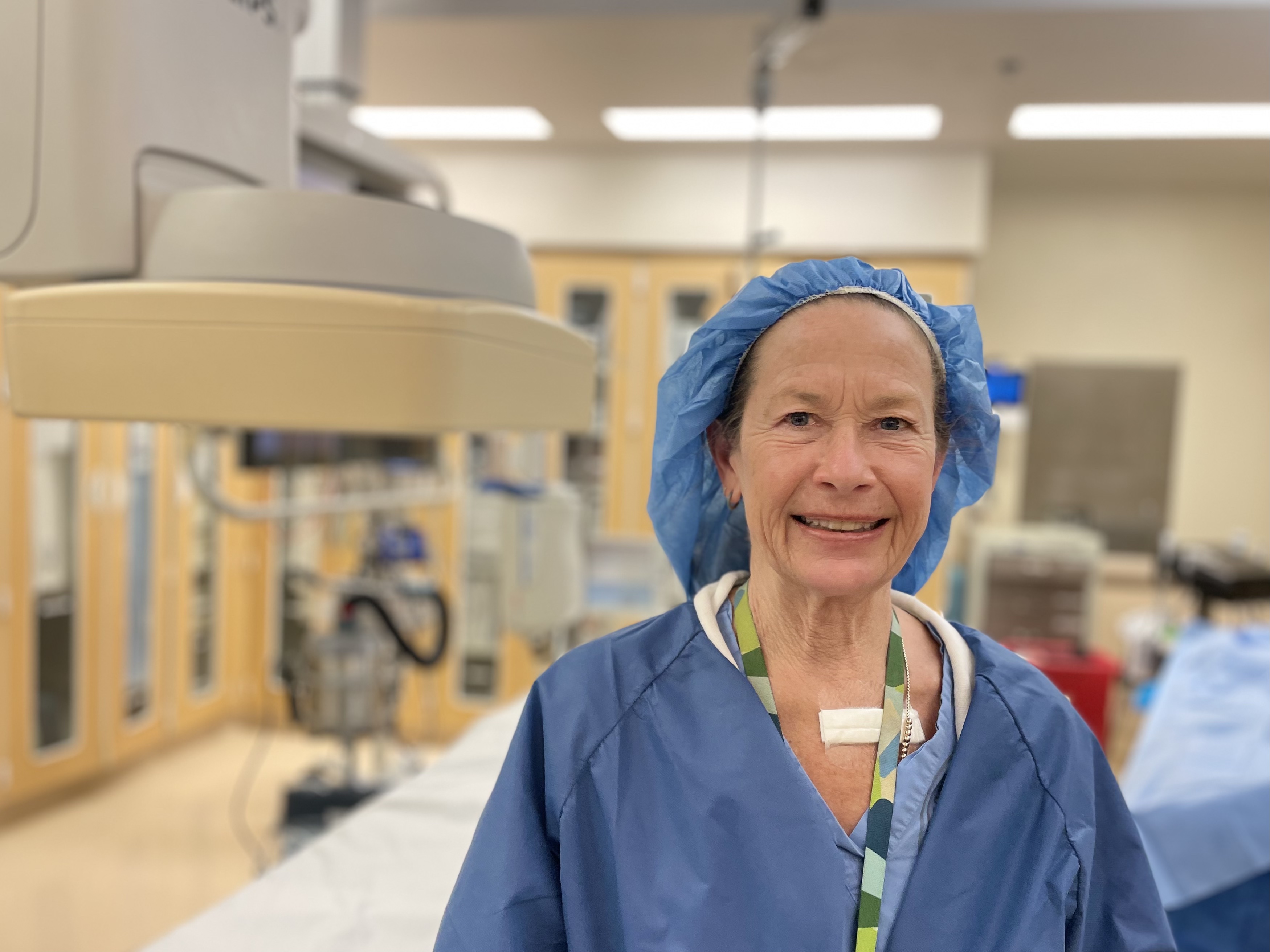 Nurse Ellen Makela, at UCSF Helen Diller Medical Center at Parnassus Heights. A woman standing in a patient exam room at UCSF Medical Center.