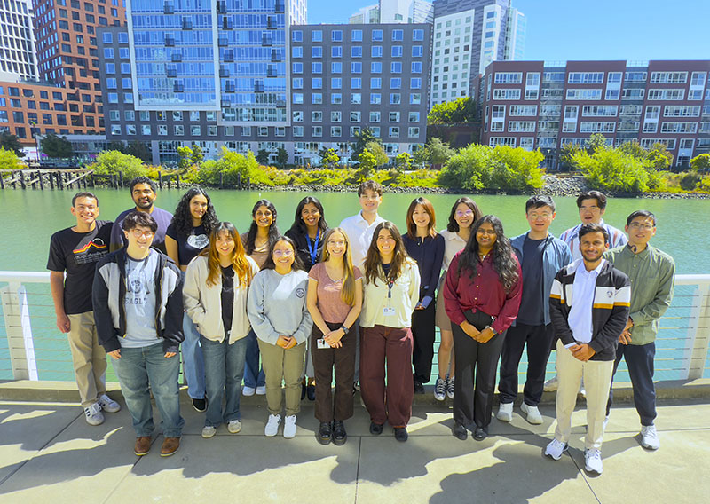 Group photo of students outside in front of buildings
