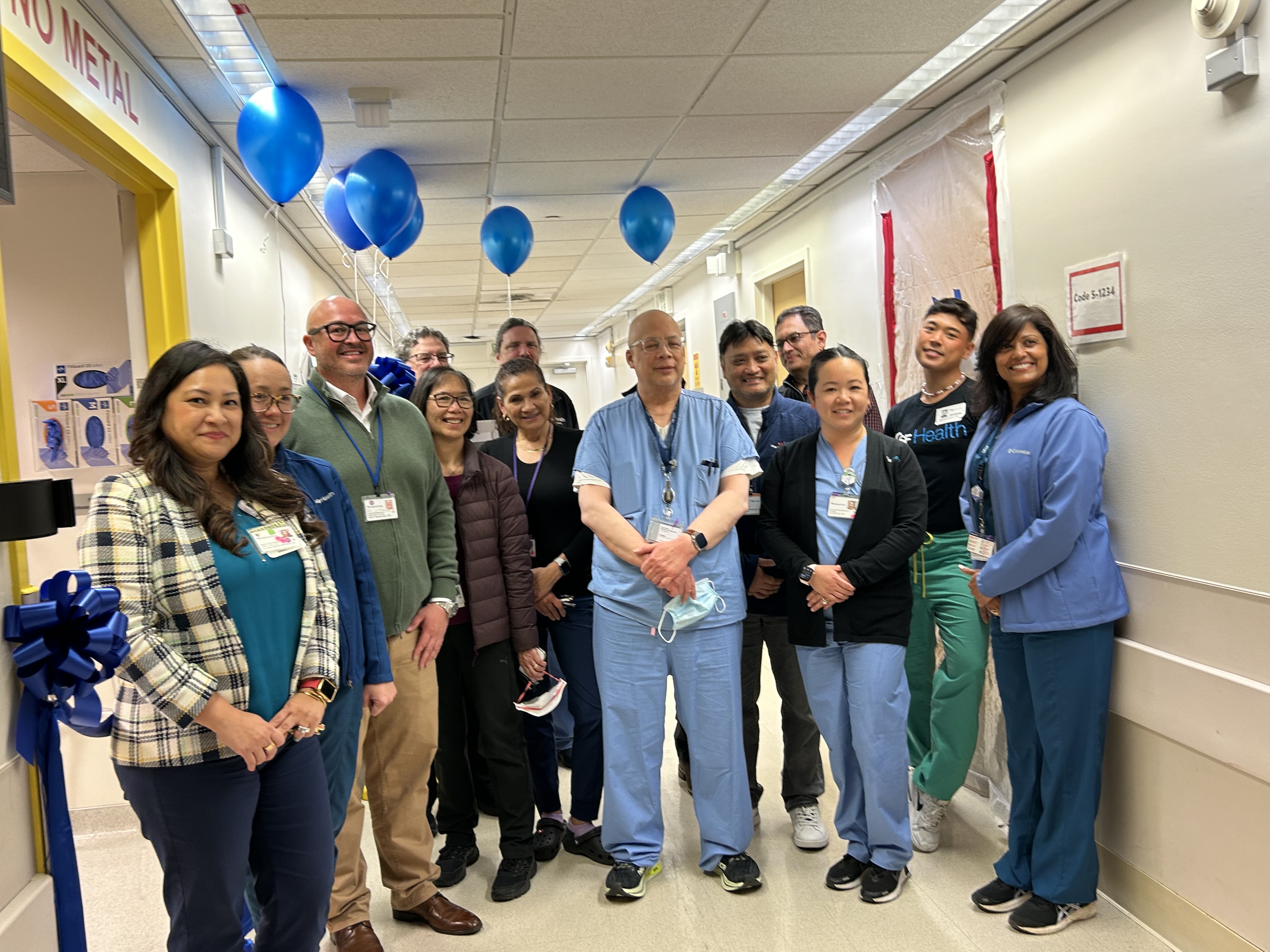 Members of the Mount Zion radiology team, hospital staff, UCSF Health, and the Department of Radiology came to celebrate the opening of the refreshed MRI Zone 3 room. The ribbon-cutting for the refreshed room was accompanied by balloons, coffee, and cupcakes. Group photo at celebration
