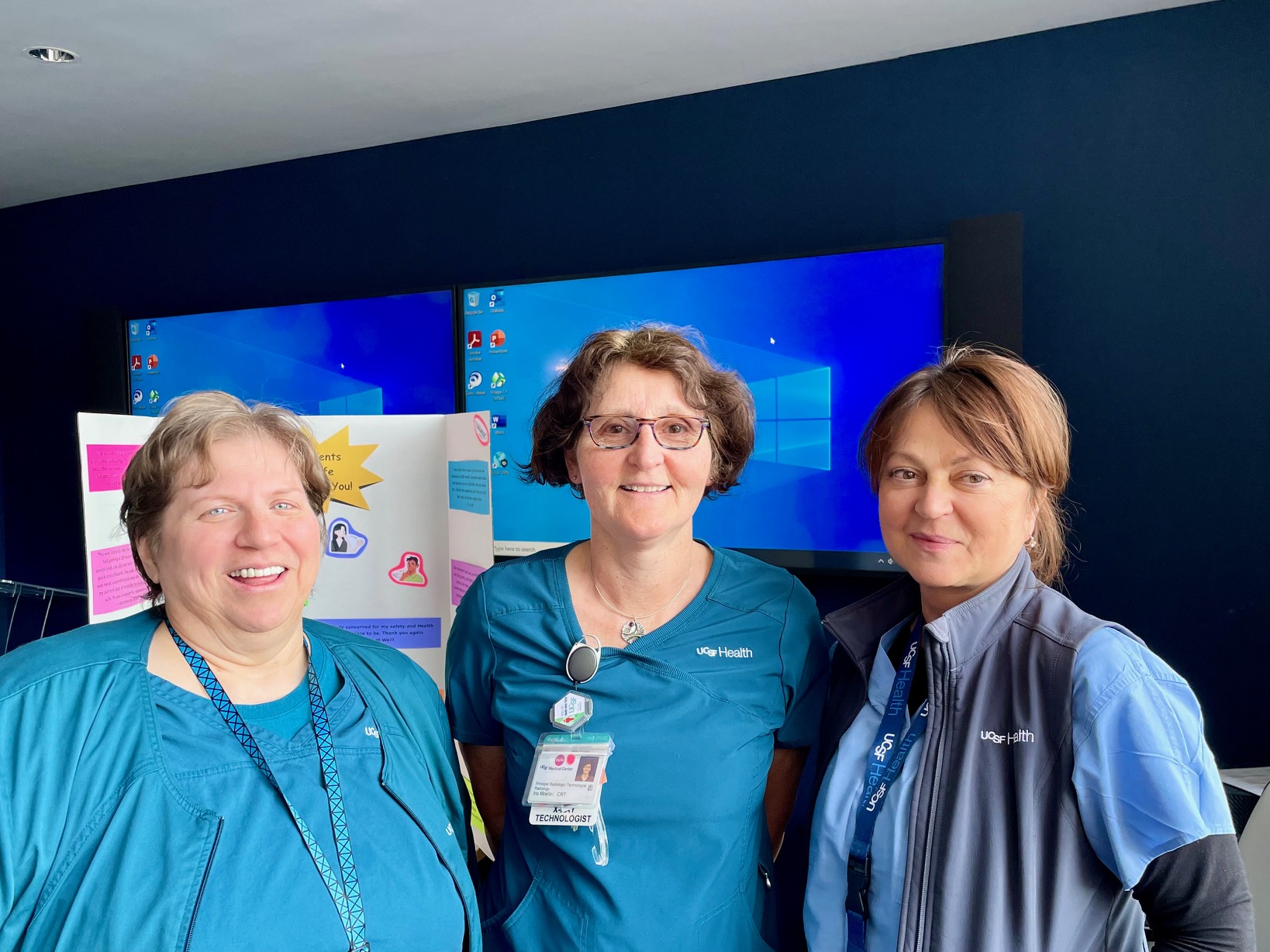 Technologists Carrie Dore, Iris Moeller, and Elena Fleischer at UCSF Parnassus Heights. Three women from the Radiology team are smiling.