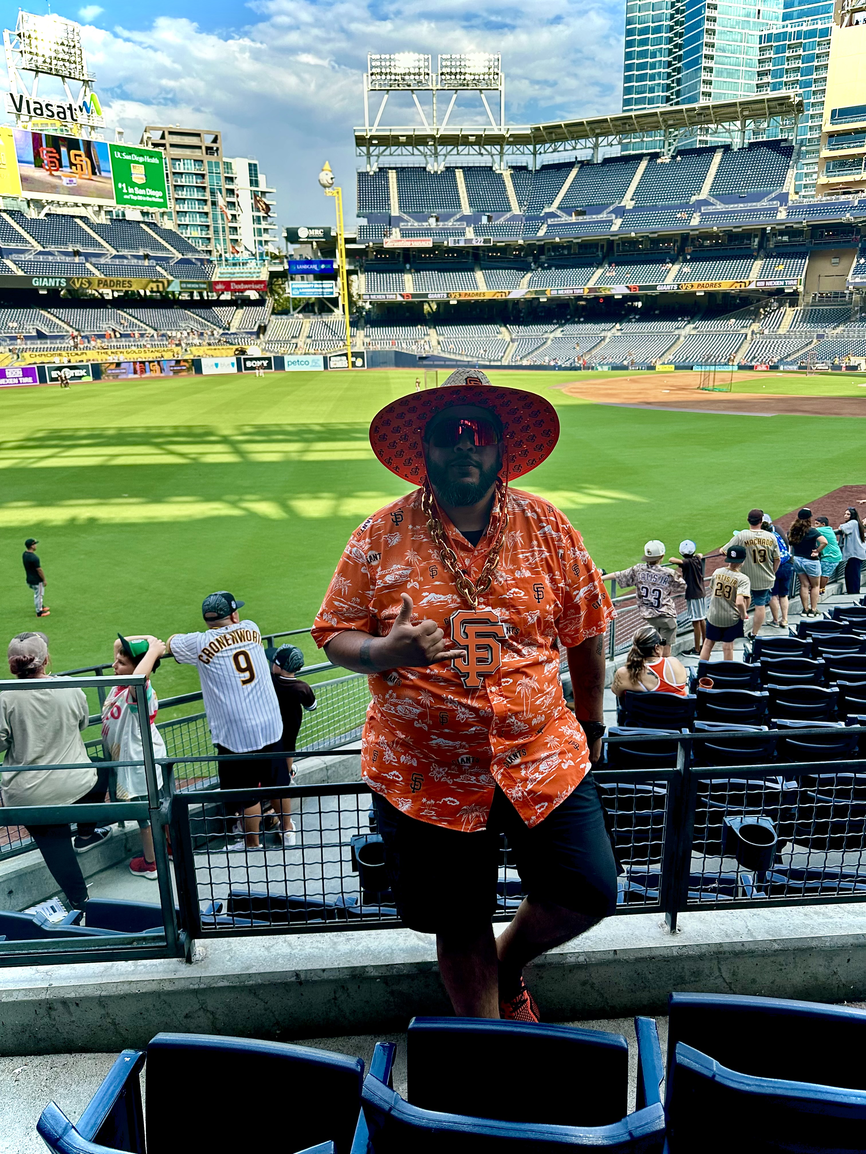 Rudy Baltodano, a lifelong fan of his hometown team, the San Francisco Giants! A man dressed in San Francisco Giants gear standing in front of the baseball field at Oracle Park in San Francisco.