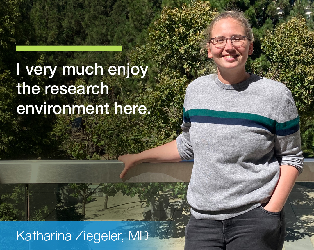 Woman in grey shirt with text saying I very much enjoy the research environment
