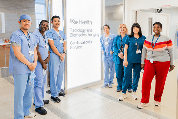 A group of radiologic technicians wearing scrubs at the Cardiovascular Services at UCSF Radiology.