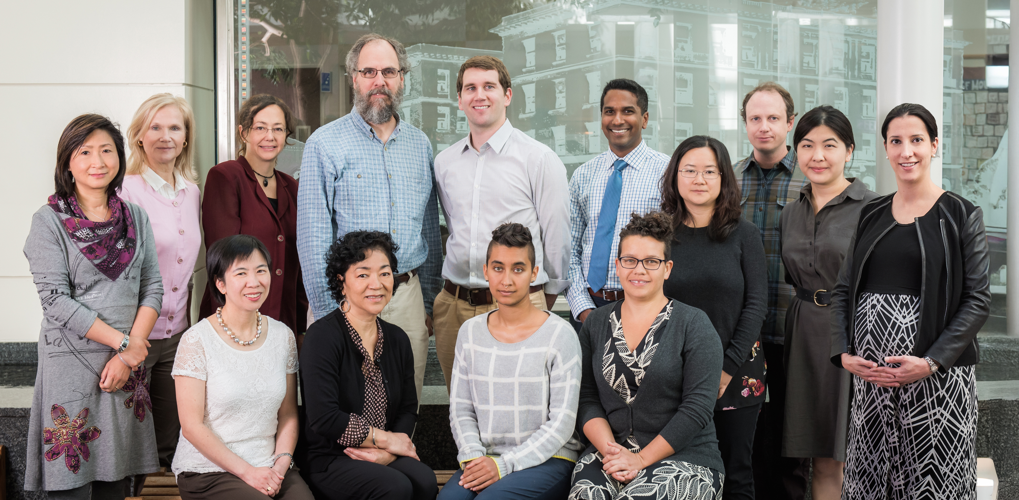Group photo of the Breast Imaging Research Program team, with fifteen people standing and seated together in an indoor setting.