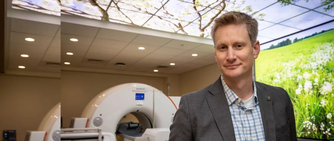 Radiologist standing in front of PET CT scanner