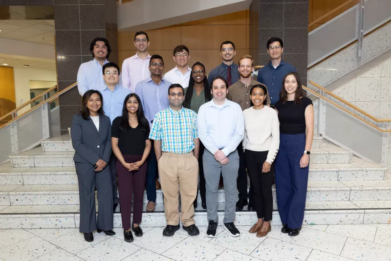 fifteen people standing on a staircase