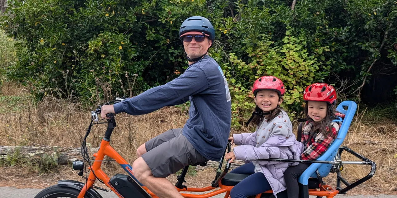 Joseph Blecha riding a bicycle with his kids