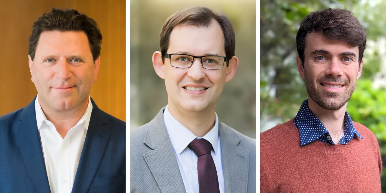 Group photo showing three people. On the left is a man with dark hair wearing a navy blazer and white shirt. In the center is a man with short brown hair, glasses, and a gray suit with a maroon tie. On the right is a man with short dark hair and a trimmed beard, wearing a rust-colored sweater over a blue patterned shirt.