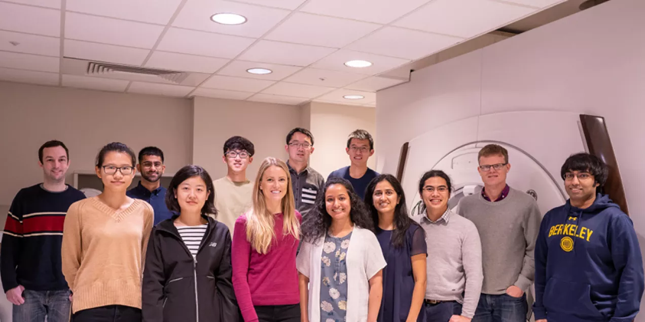 Larson Lab group photo in an MRI room with the scanner in the background.
