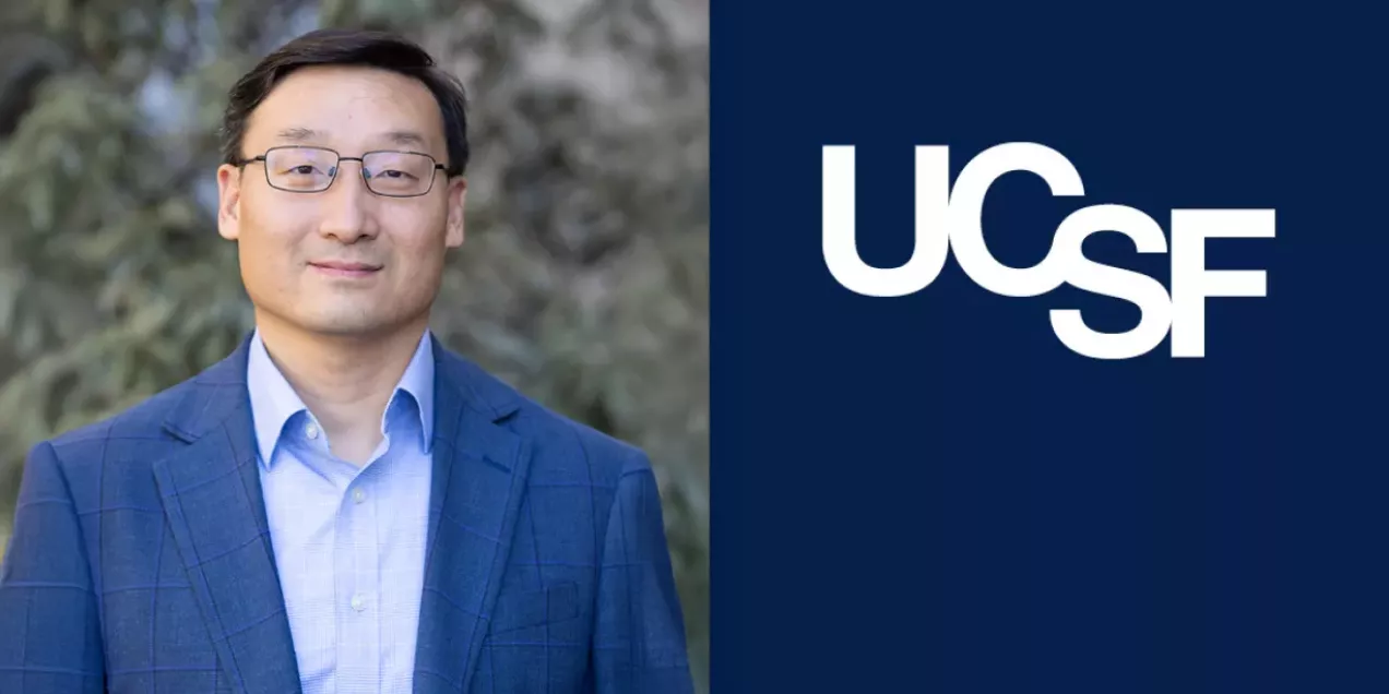 Portrait of a man wearing glasses and a blue blazer over a light blue shirt, standing outdoors with a blurred natural background. On the right side, a dark blue panel displays the UCSF logo in white.