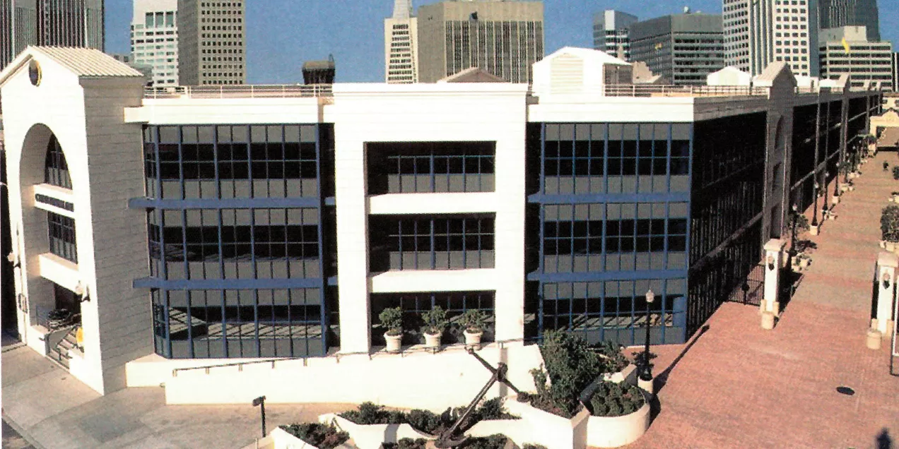 Exterior view of the UCSF China Basin building with the San Francisco skyline in the background.