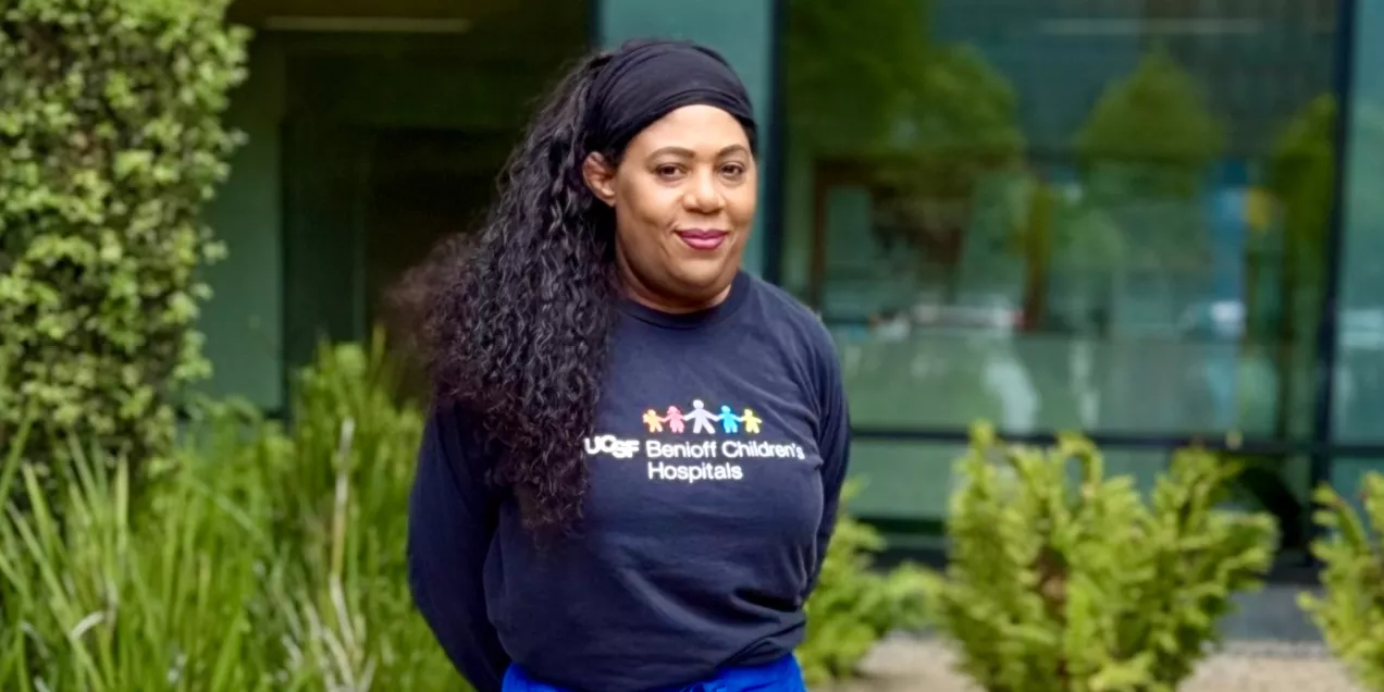 Woman wearing a UCSF Benioff Children's Hospitals T-shirt outdoors.