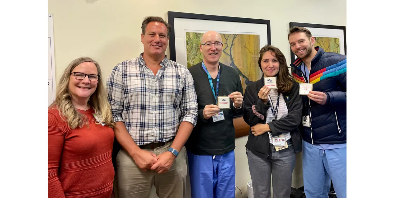 Five healthcare staff members pose together, with several holding UCSF MRI Safety Week cookies.