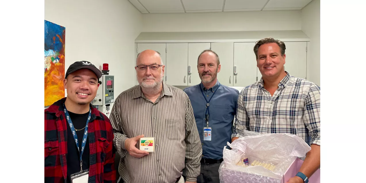 Four staff members pose together in a clinical workspace with MRI Safety Week treats.