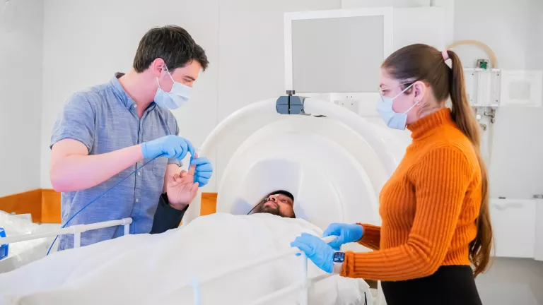 A patient is prepped for a brain imaging exam