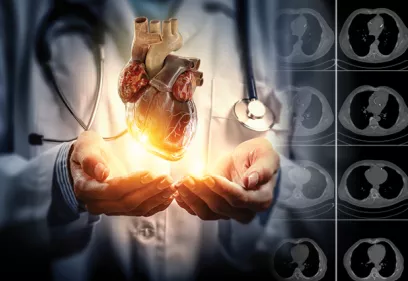 doctor holding an illuminated 3D heart model in their hands with CT chest scan slices displayed along the right side of the image