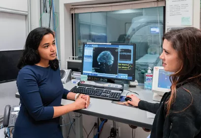 Group of researchers and clinicians standing together in hospital atrium