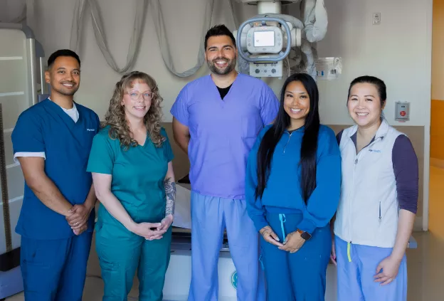 Members of the musculoskeletal radiology team stand together in a clinical setting at the Orthopedic Institute.