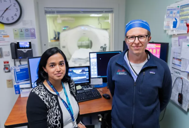 Neuroradiologists in front of scanner