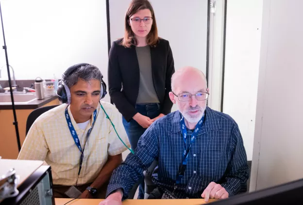 Brain imaging researchers collaborating at computer workstation