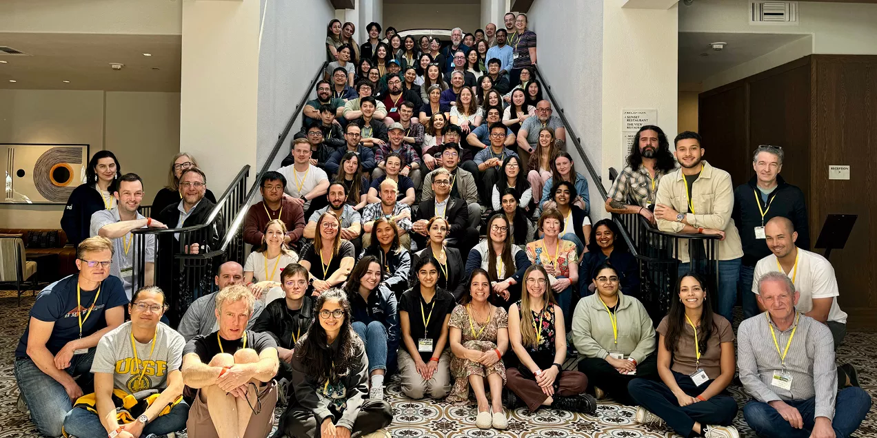 Large group photo of UCSF Radiology researchers on a hotel staircase with a banner reading 11th Annual Research Conference, March 29–31, 2026