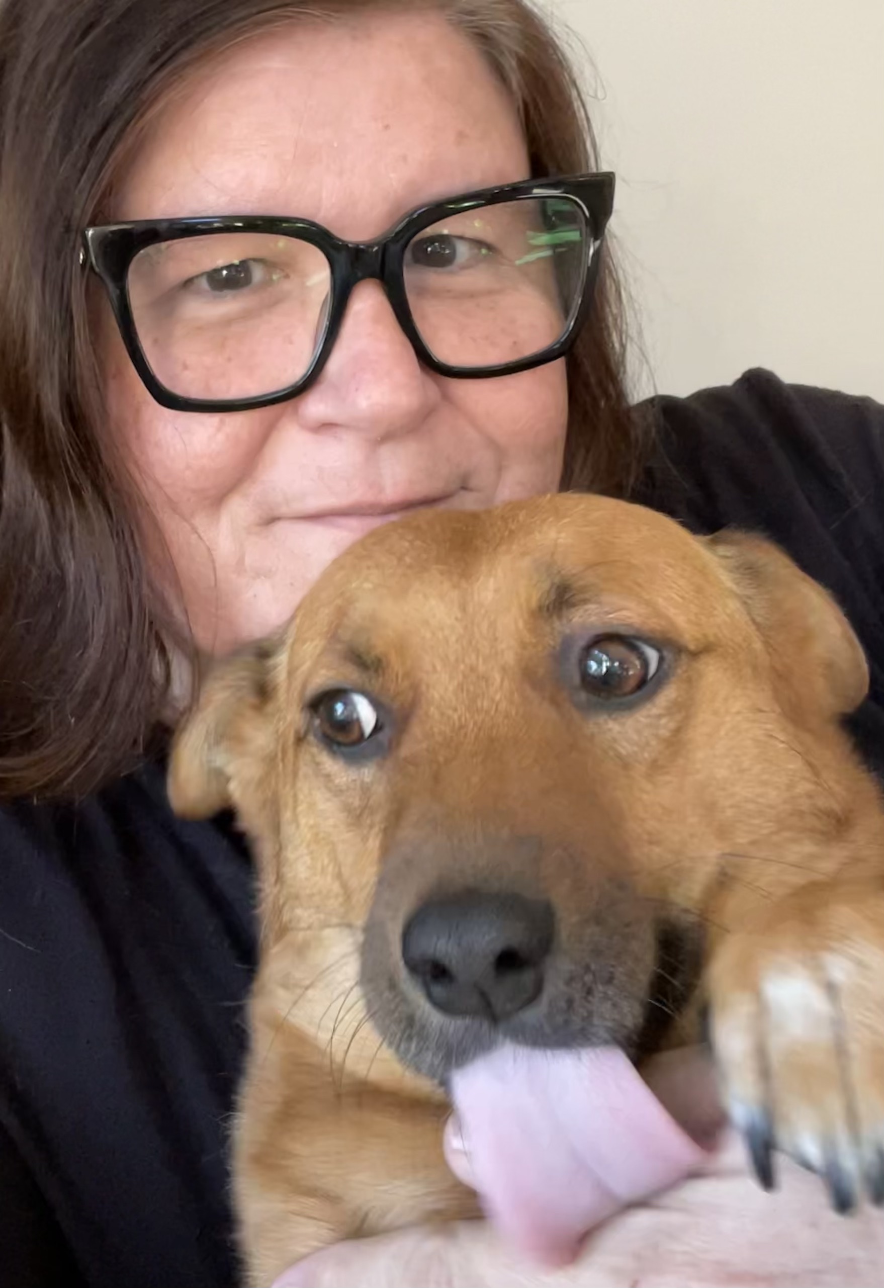 Teri Moore holding her dog Reggie.