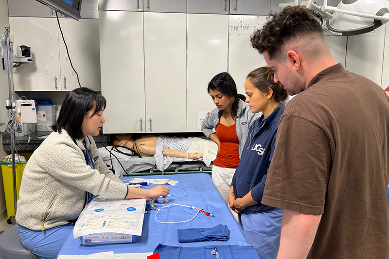 Students watching teacher demonstrating an Ultrasound procedure 