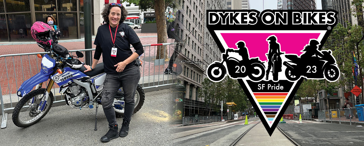 Victoria Odson downtown San Francisco standing next to motorcycle and t-shirt design for Dykes on Bikes 2023.